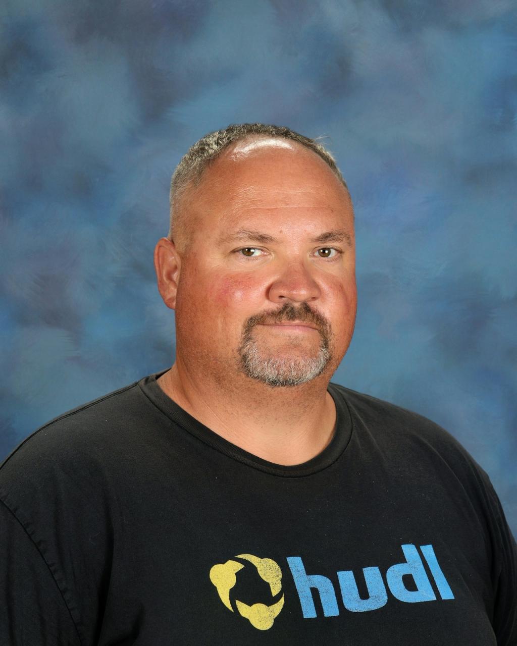 Man with a black shirt, beard and mustache